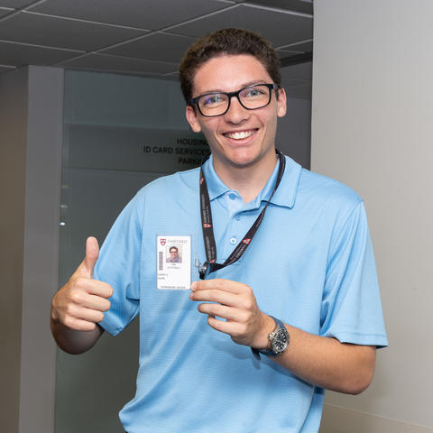 Person smiling with ID card