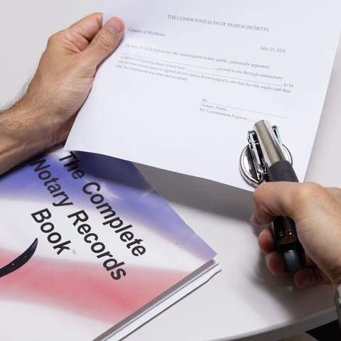 person stamping an official document